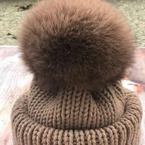 Knitted hat with real fluffy pompom